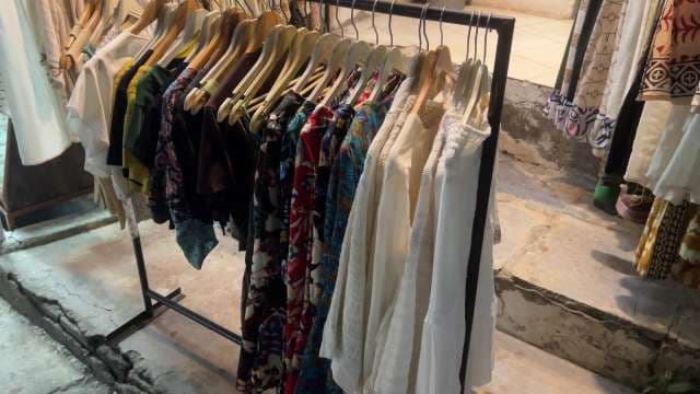 Colorful Garments Displayed on Clothing Rack in Market