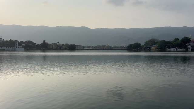 Scenic Lakefront View With Distant Mountains at Sunset