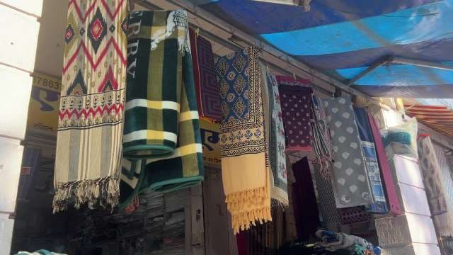 Colorful Wool Blankets and Throws Displayed at Market Stall