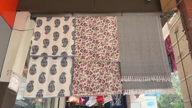 Colorful Printed Fabrics Displayed at Local Market Stall