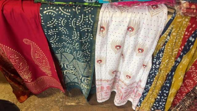 Colorful Traditional Indian Fabrics Displayed in Market Stall