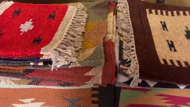 Colorful Handwoven Rugs Displayed in Artisan Market