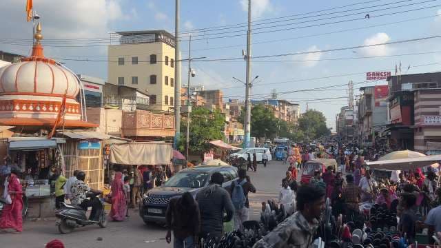 Busy Indian Street Market With Temple And Crowd Activity