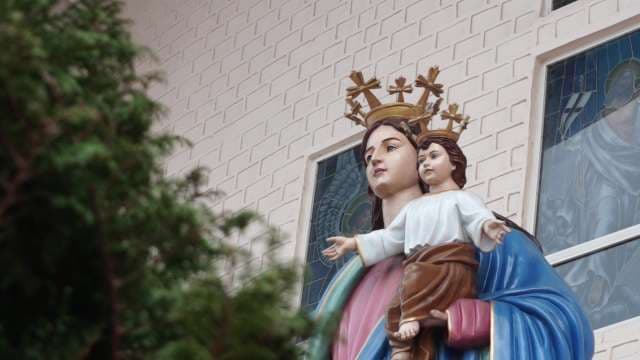 Statue of the Virgin Mary With Child Outside Church