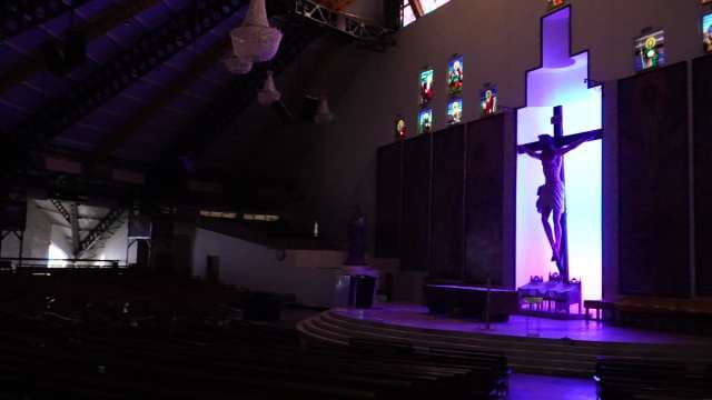 Modern Church Interior With Illuminated Crucifix and Stained Glass