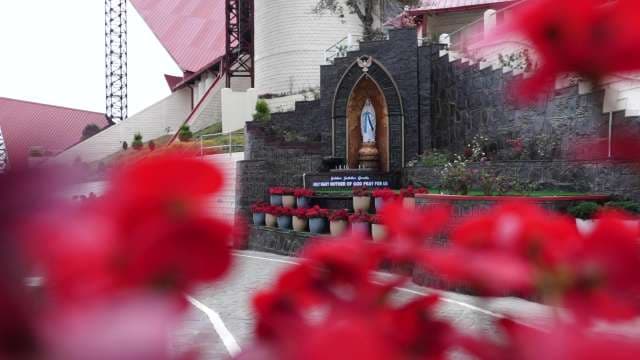 Statue of Virgin Mary at National Shrine with Red Flowers