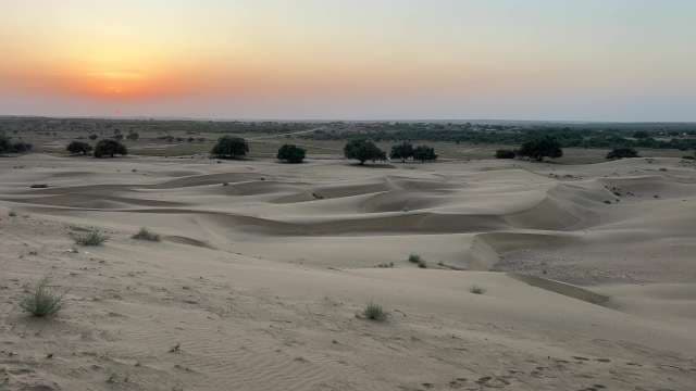 Golden Desert Sunset Over Peaceful Sand Dunes