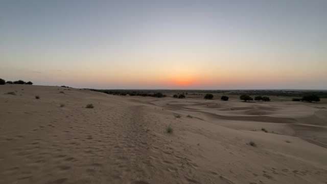 Golden Desert Sunset Over Vast Sandy Dunes