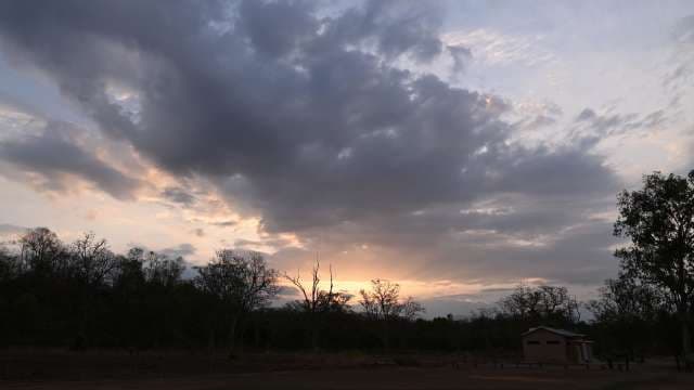 Dramatic Sunset Skies Over Rural Landscape