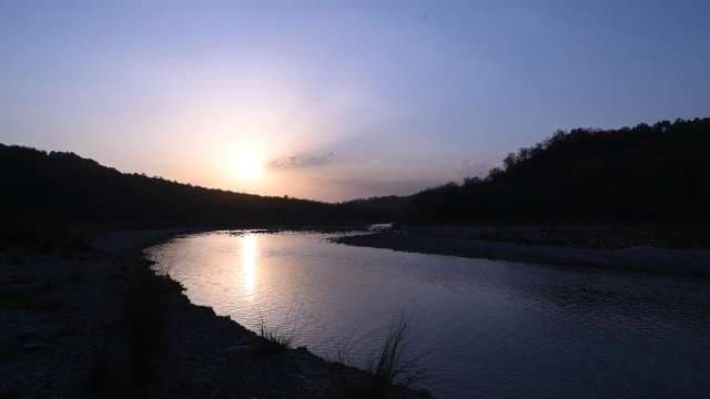 Serene River Sunset Over Gently Flowing Water