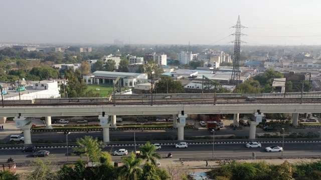 Modern Urban Landscape With Elevated Metro and City Traffic