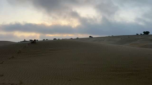 Serene Sunrise Over Tranquil Desert Dunes