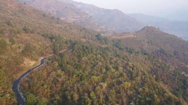 Winding Mountain Road Through Scenic Hillside Landscape