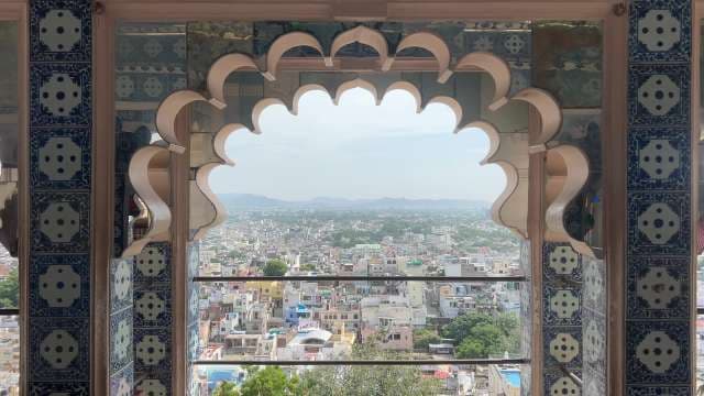 Stunning Jaipur Cityscape View Through Ornate Palace Window
