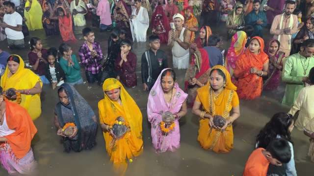 Devotees Celebrate Chhath Puja with Ritual Offerings in River