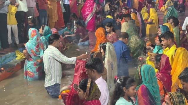 Chhath Puja Devotees Gather for Rituals at Riverbank