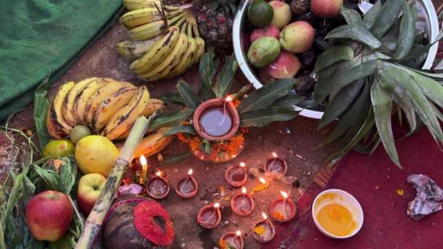 Traditional Hindu Puja Fruit Offering Ritual with Diyas