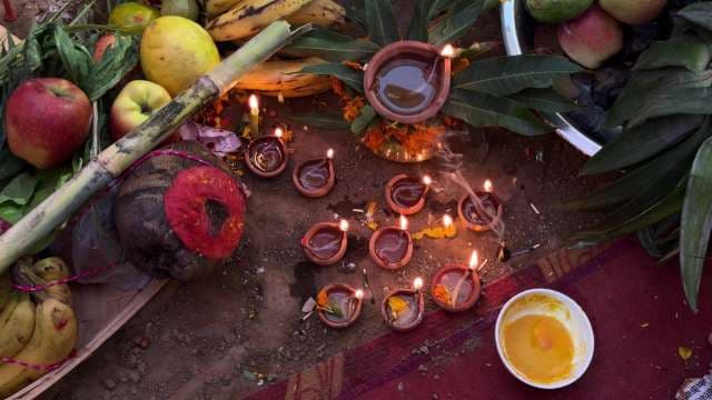 Traditional Hindu Ritual with Diyas and Offerings