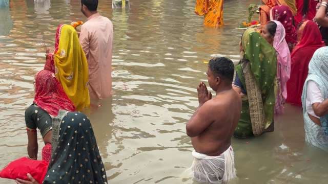 Devotees Performing Chhath Puja Rituals in River Waters