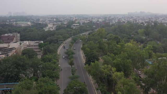 Aerial View of Urban Highway Amid Greenery