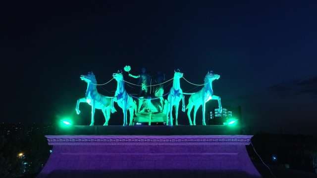 Glowing Neon Horse Chariot Sculpture at Night