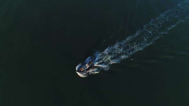Aerial View of Boat Creating Wake in Ocean Water