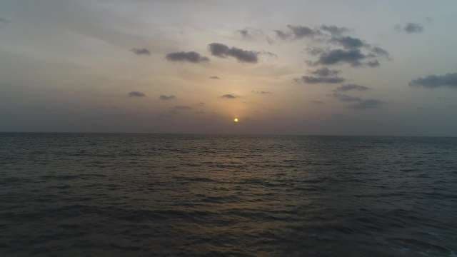 Serene Ocean Sunset with Golden Sky and Clouds
