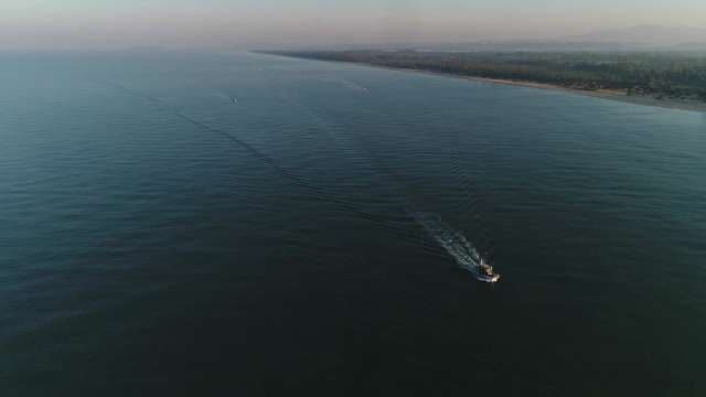 Aerial View of Boat Cruising Across Open Ocean Waters