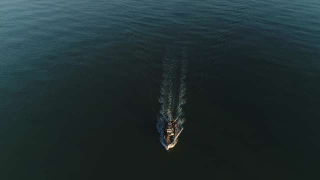 Cargo Ship Cutting Through Open Waters Aerial View