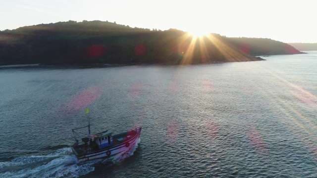 Sunrise Over Coastal Waters With Traditional Fishing Boat