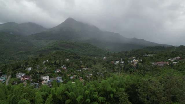 Aerial View of Mountain Village Nestled in Lush Valleys