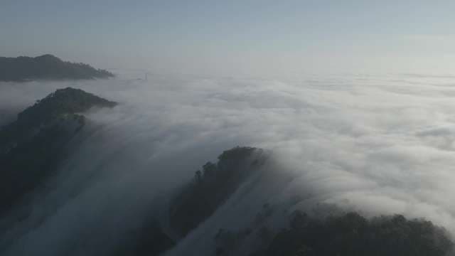Misty Mountain Peaks Rising Above Clouds
