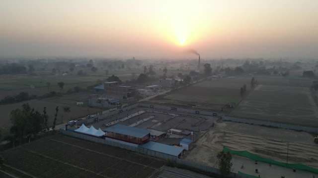 Aerial Farmland at Sunrise with Agricultural Facility
