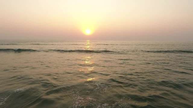 Golden Sunset Over Ocean Waves at Beach