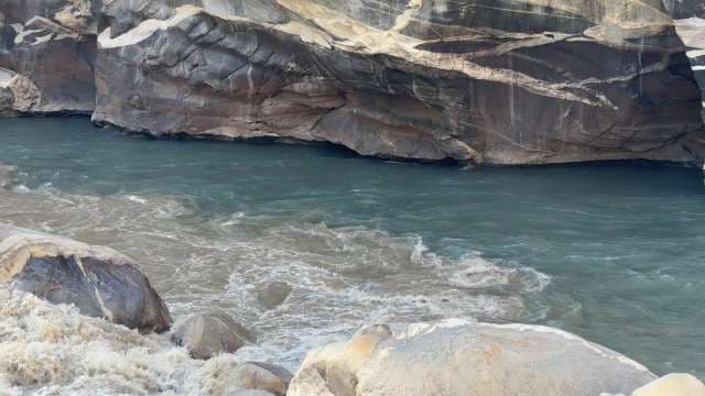 Turquoise Mountain River Flowing Through Rocky Gorge