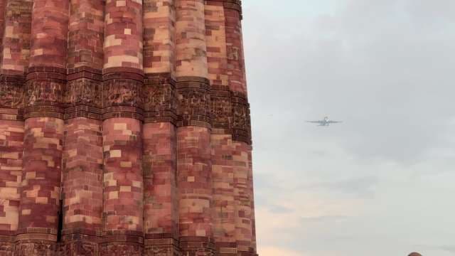Aeroplane Flying Over The Qutub Minar
