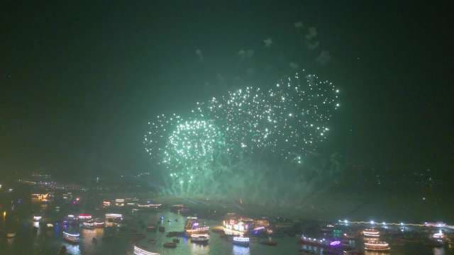 Spectacular Fireworks Display Over River at Night