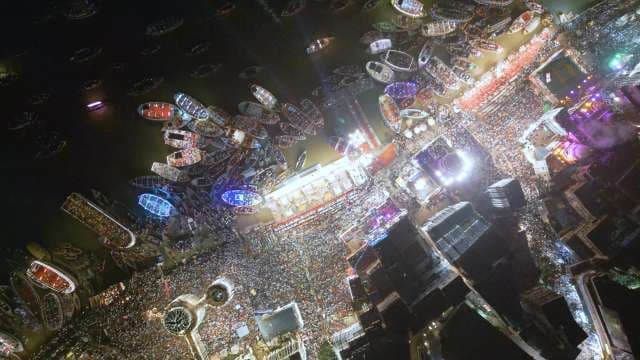 Aerial Night View of Bustling Harbor with Illuminated Vessels