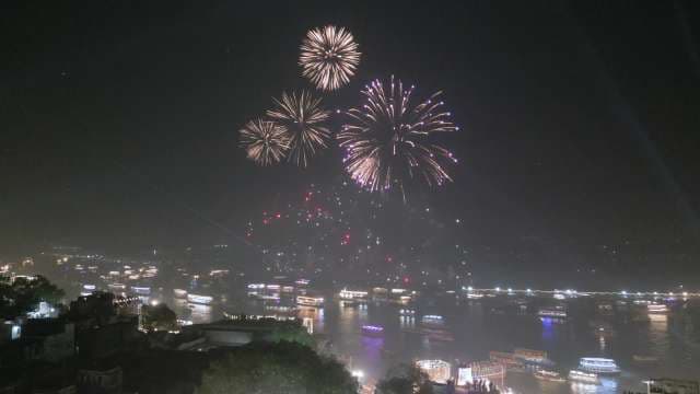 Spectacular Fireworks Display Over River at Night