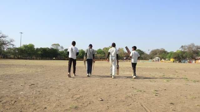 Kids Walking onto Cricket Ground for Playing Cricket