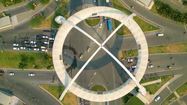 Aerial View of Modern Circular Architecture and Urban Traffic