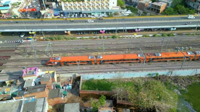 Aerial View of High-Speed Orange Vande Bharat Express in India