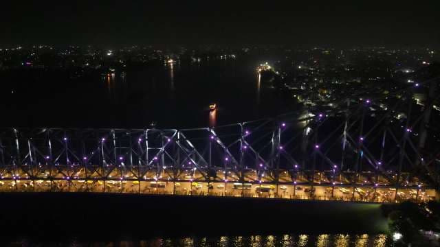 Aerial Night View of the Illuminated Howrah Bridge in Kolkata