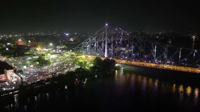 Illuminated Howrah Bridge and Nighttime Kolkata Cityscape Over Hooghly River