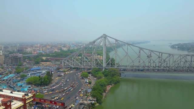 Aerial View of Iconic Howrah Bridge and Bustling Traffic in Kolkata
