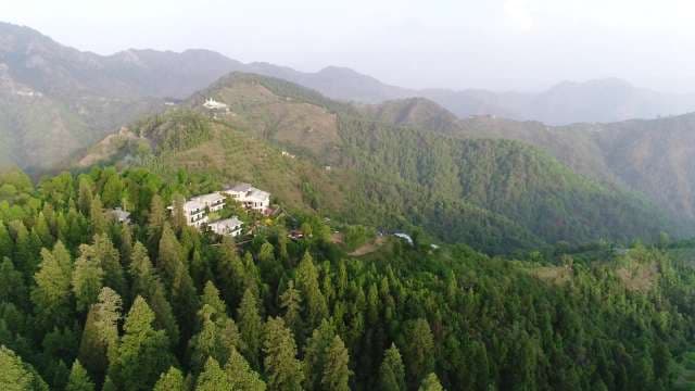 Stunning Aerial Vista of Lush Green Himalayan Mountains and Luxury Resorts