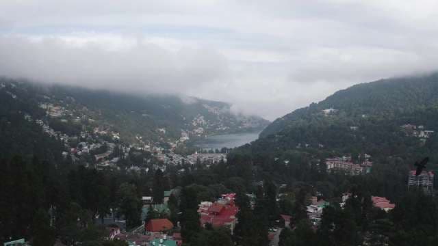 Scenic Aerial View of Nainital Lake and Hill Station Under Foggy Skies