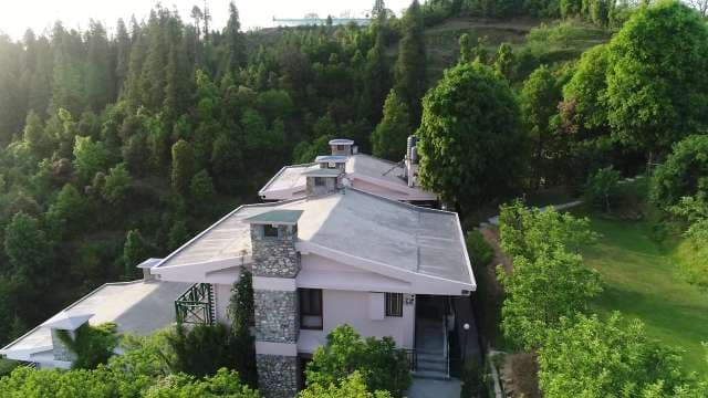 Serene Mountain Retreat: Aerial View of a Luxury Forest Cottage