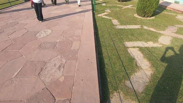 Tourists Walking on Historic Stone Path at Taj Mahal Gardens
