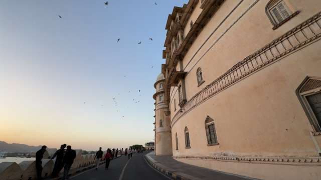 Majestic City Palace in Udaipur at Sunset with Soaring Birds